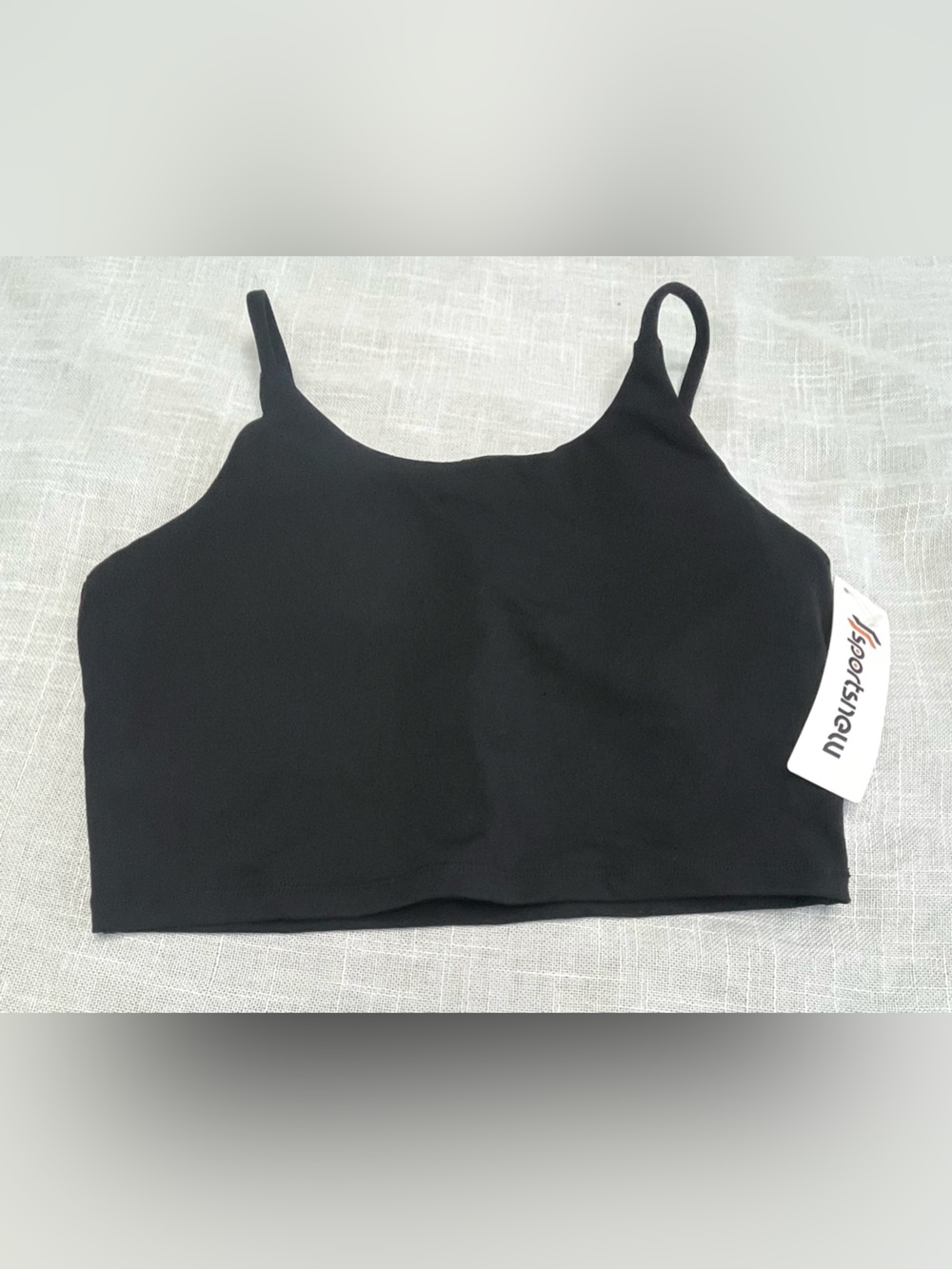 Black sports bra with thin straps and removable pads.